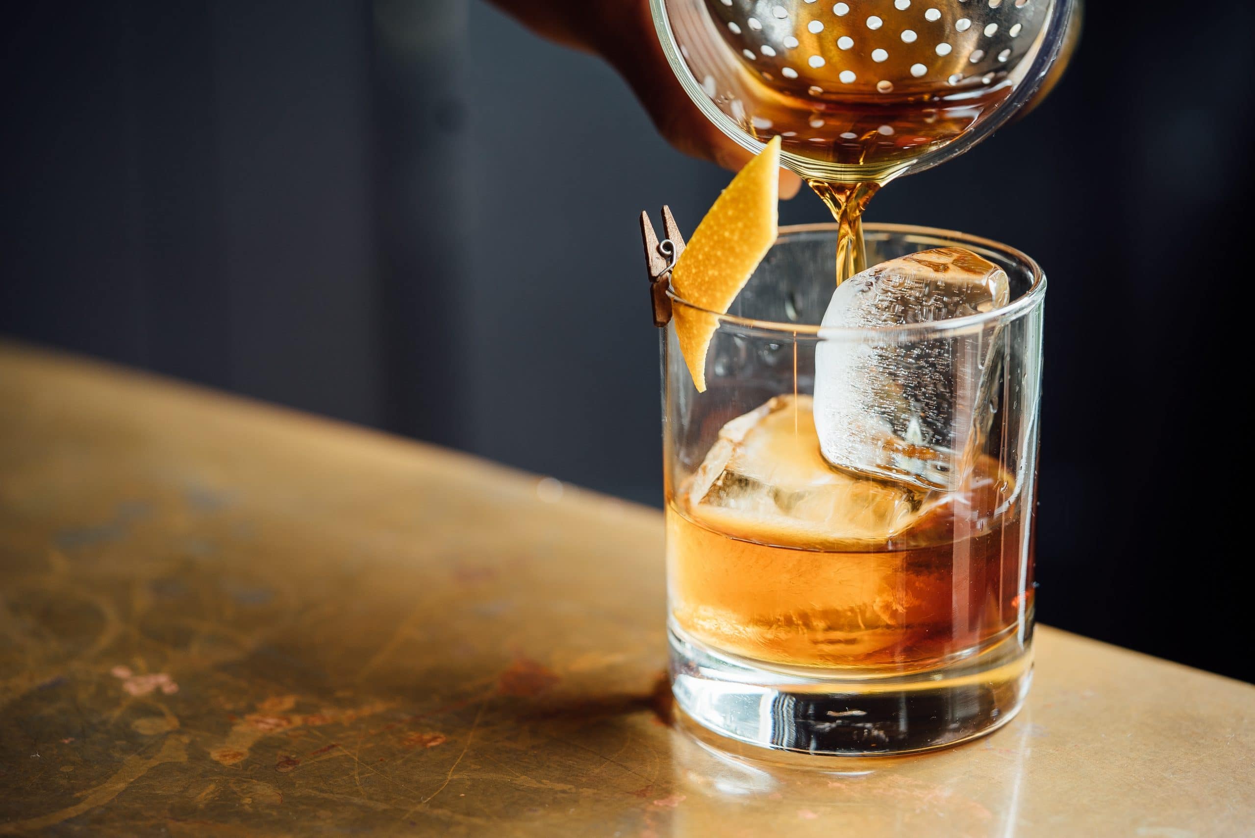 Verre de whisky avec glaçons et zeste d'orange